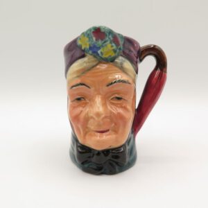 ceramic creamer with the face of granny on it