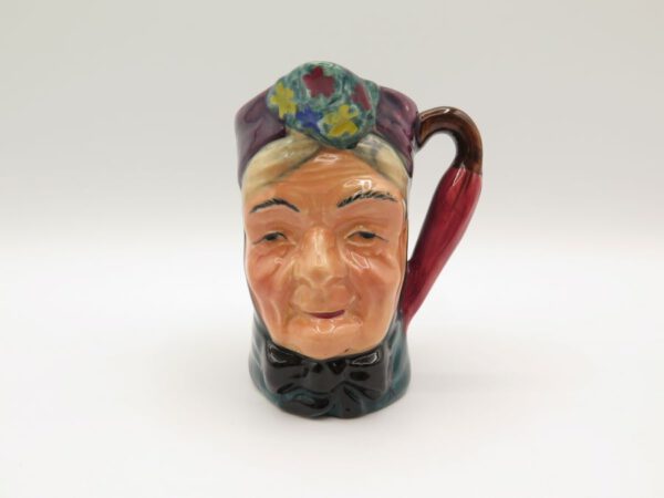 ceramic creamer with the face of granny on it