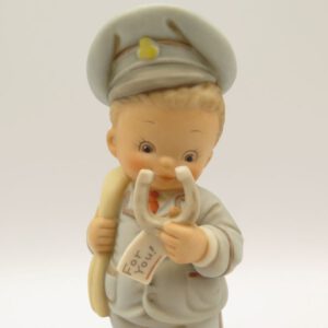 ceramic figurine of boy dressed as a mailman