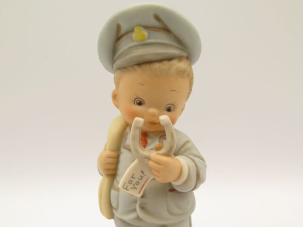 ceramic figurine of boy dressed as a mailman