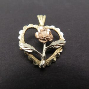 pendant of a rose inside a heart