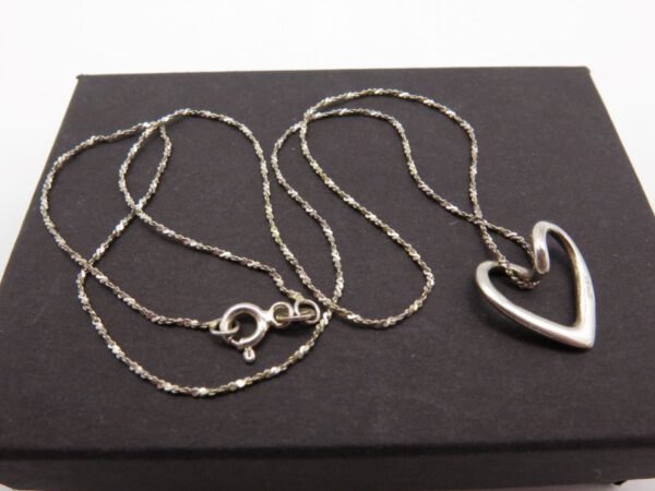 silver necklace with heart shaped pendant