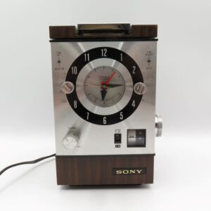 silver and wood grain clock radio