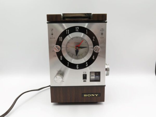 silver and wood grain clock radio