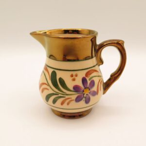 ceramic creamer decorated with flowers