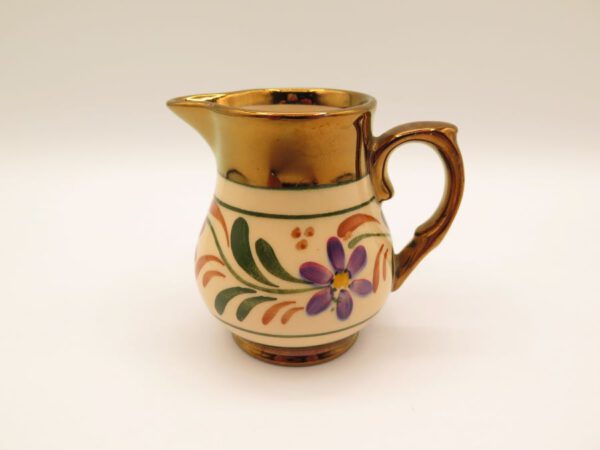 ceramic creamer decorated with flowers